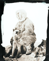 Image of Donald MacMillan kneeling by dog